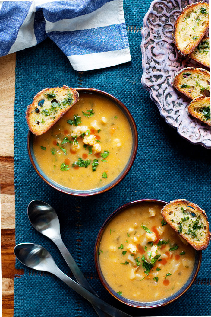 Vegan Buffalo Cauliflower Chowder with Herbed Crostini - This hearty, veggie-packed chowder recipe packs a kicky wallop, buffalo hot sauce style. Creamy, full of flavor, and, yep, vegan - though the carnivores will no doubt be clamoring for seconds, too! Don't forget the crisp broiled crostini for some delicious dipping.