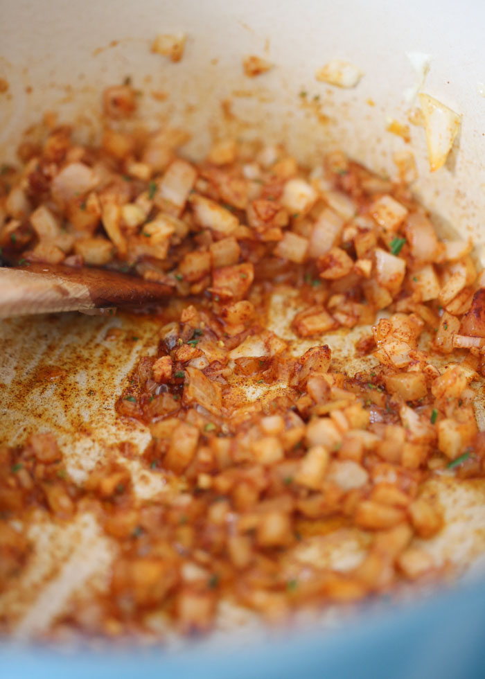 Sauteeing the aromatics, seasonings, and herbs for a pasta e fagioli recipe.