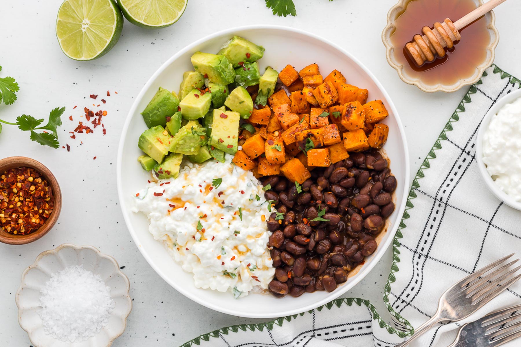 vegetarian cottage cheese bowls with limes and cilantro in the background
