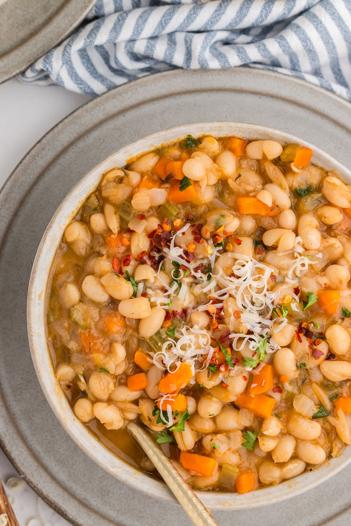 Top view of White bowl full of Vegetarian Navy Bean Soup
