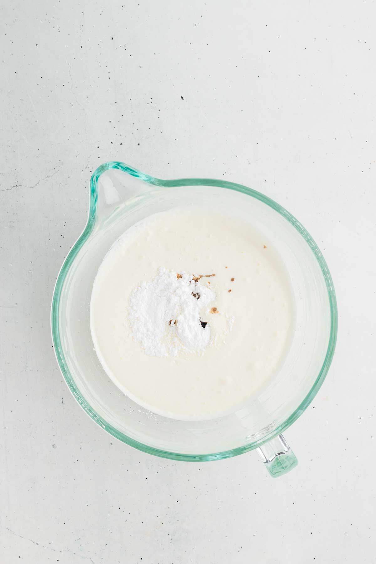 Adding vanilla and powdered sugar to heavy whipped cream